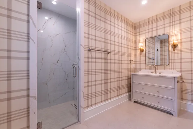 an empty room with a ceiling fan and windows