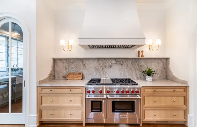 a dining room with stainless steel appliances kitchen island granite countertop a dining table chairs and view living room