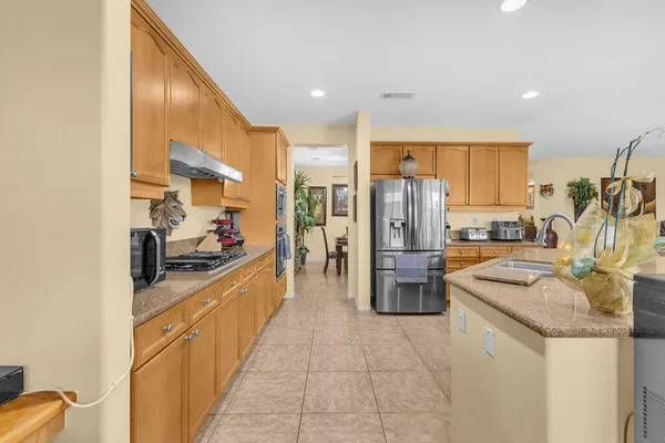 a kitchen with stainless steel appliances granite countertop a refrigerator and stove