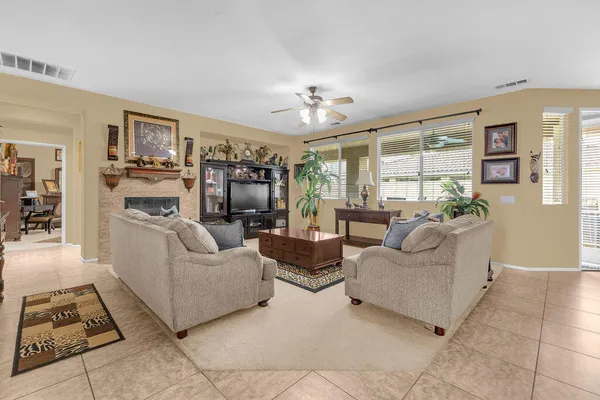 a living room with furniture a fireplace and a flat screen tv