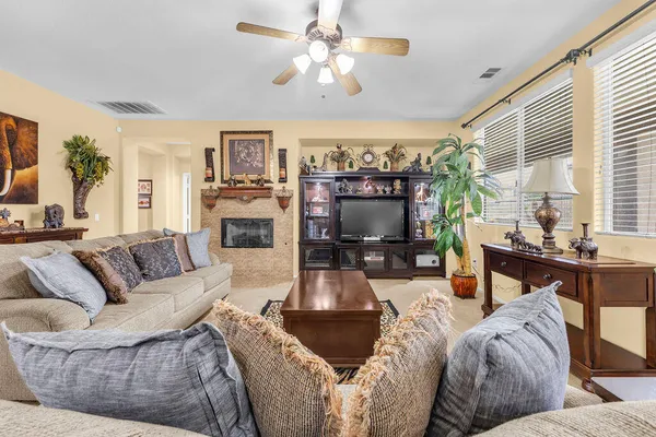 a living room with furniture and a fireplace