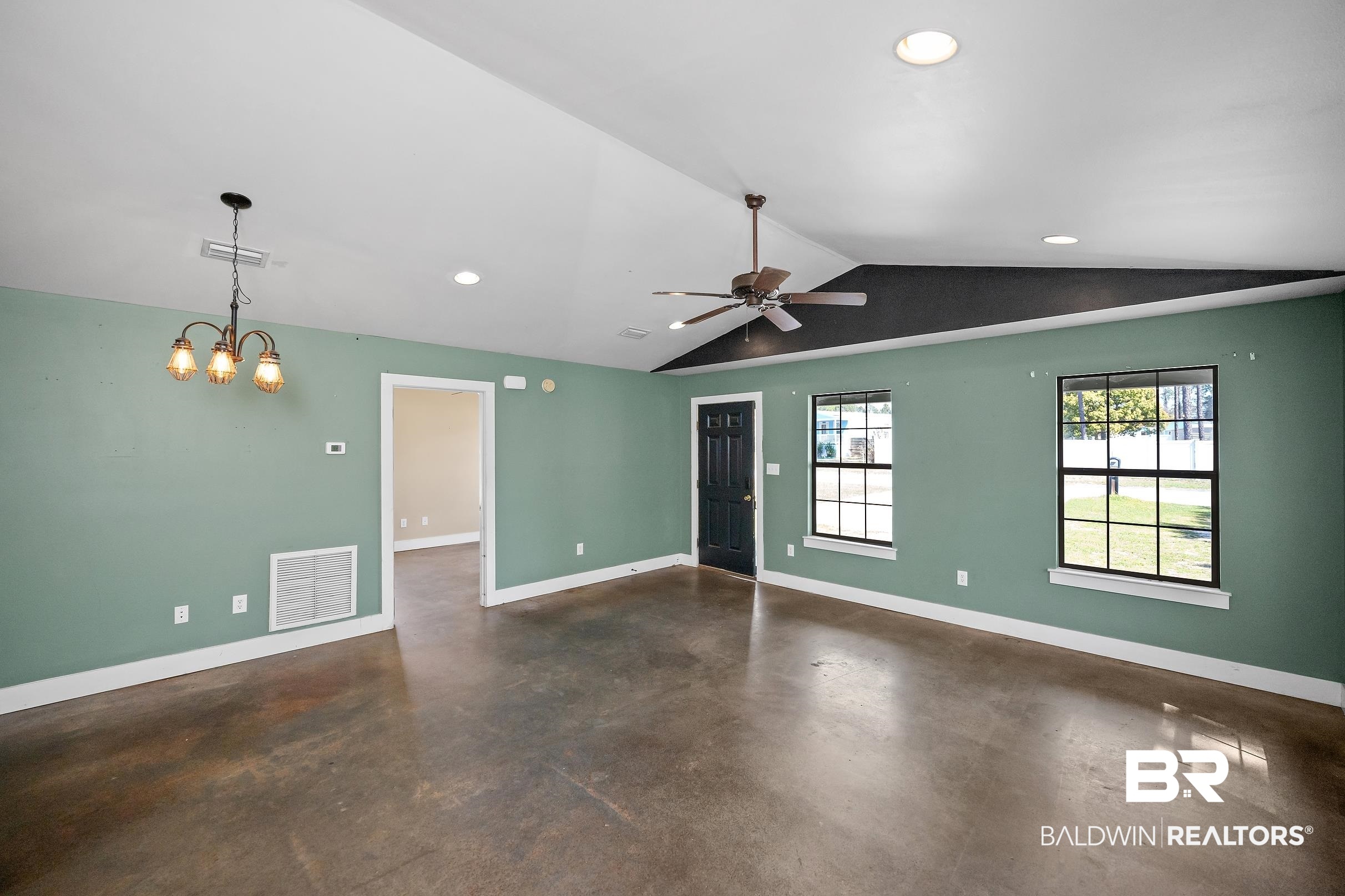 2000 Maria Lane Lillian, AL 36549 - Photo 3 of 35 Unfurnished living room with finished concrete flooring, ceiling fan, and suspended lighting