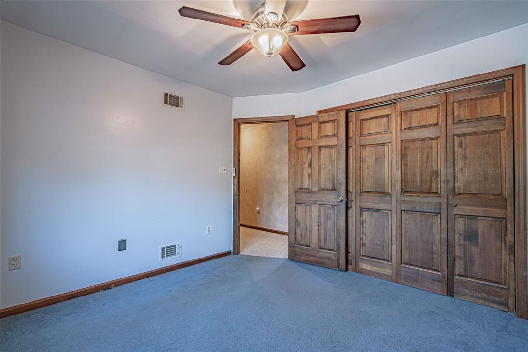 652 Old State Road Oley, PA 19547 - Photo 31 of 54 Well-appointed bedroom featuring robust wooden closet doors and a functional ceiling fan for comfort.