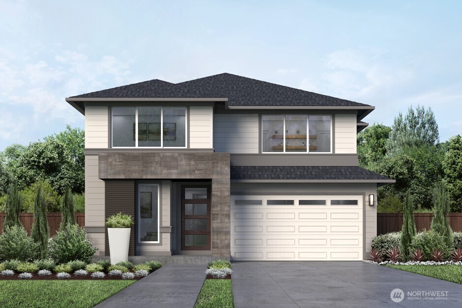 a front view of a house with a yard and garage