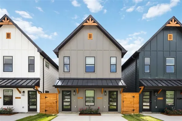 a front view of a residential apartment building with a garage