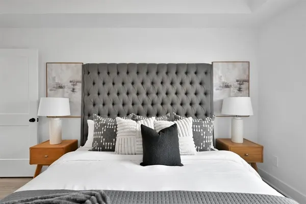 a bedroom with a bed and a lamp