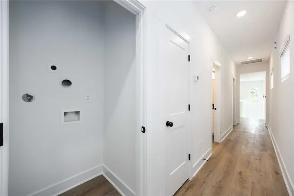 a view of a hallway with wooden floor