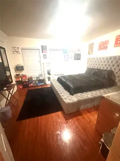 a bedroom with a bed and a rug