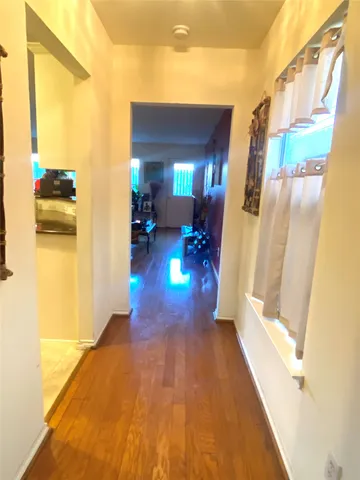 a view of a living room with a wooden floor