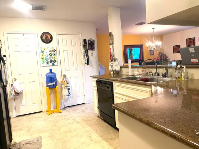 a kitchen with stainless steel appliances granite countertop a sink and a cabinets