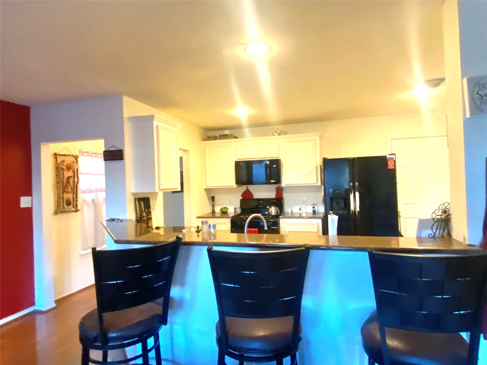 1718 Redwing Ridge Drive Houston, TX 77009 - Photo 7 of 32 a living room with couches chairs and a large window with wooden floor