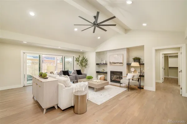 a living room with stainless steel appliances kitchen island granite countertop furniture and a view of kitchen