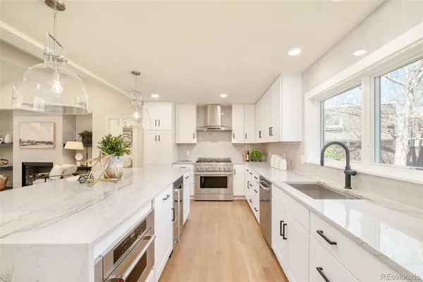 a kitchen with stainless steel appliances kitchen island granite countertop a sink and cabinets