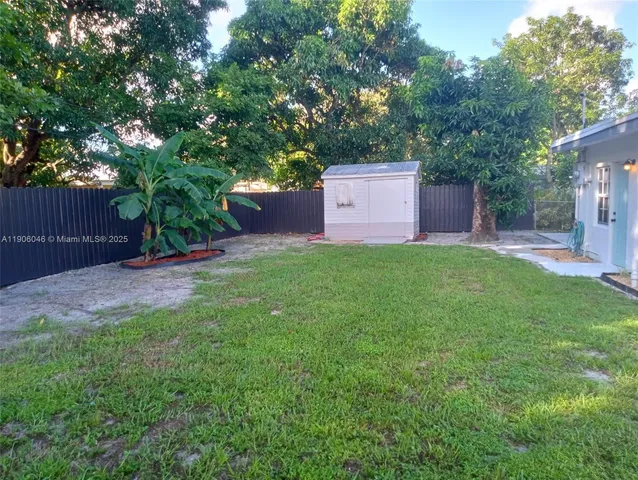 a front view of a house with a yard and tree