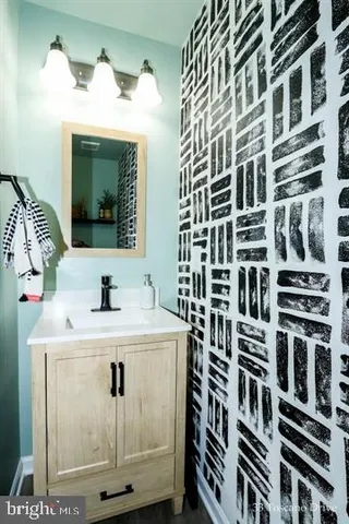 a view of a bathroom with a sink and a mirror