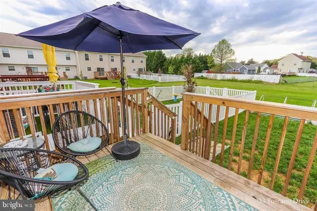 a view of a chair and tables in the patio