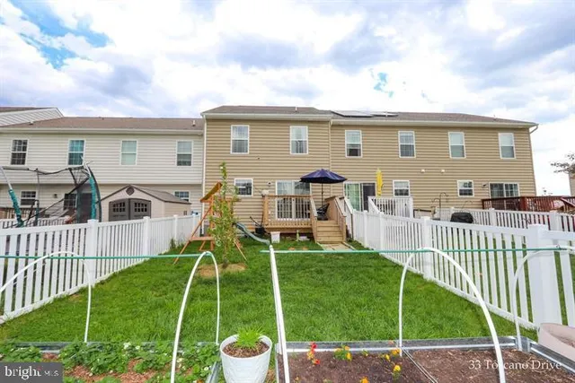 a view of a house with a yard and deck