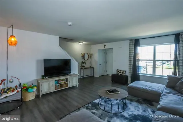 a living room with furniture and a flat screen tv