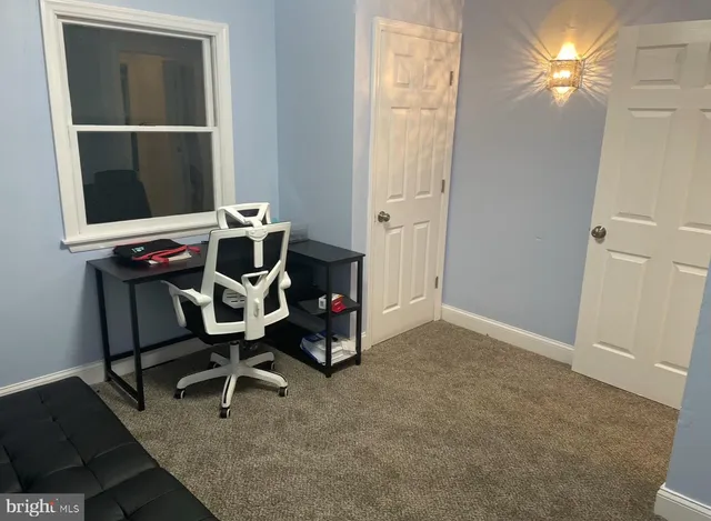 an empty room with closet and windows