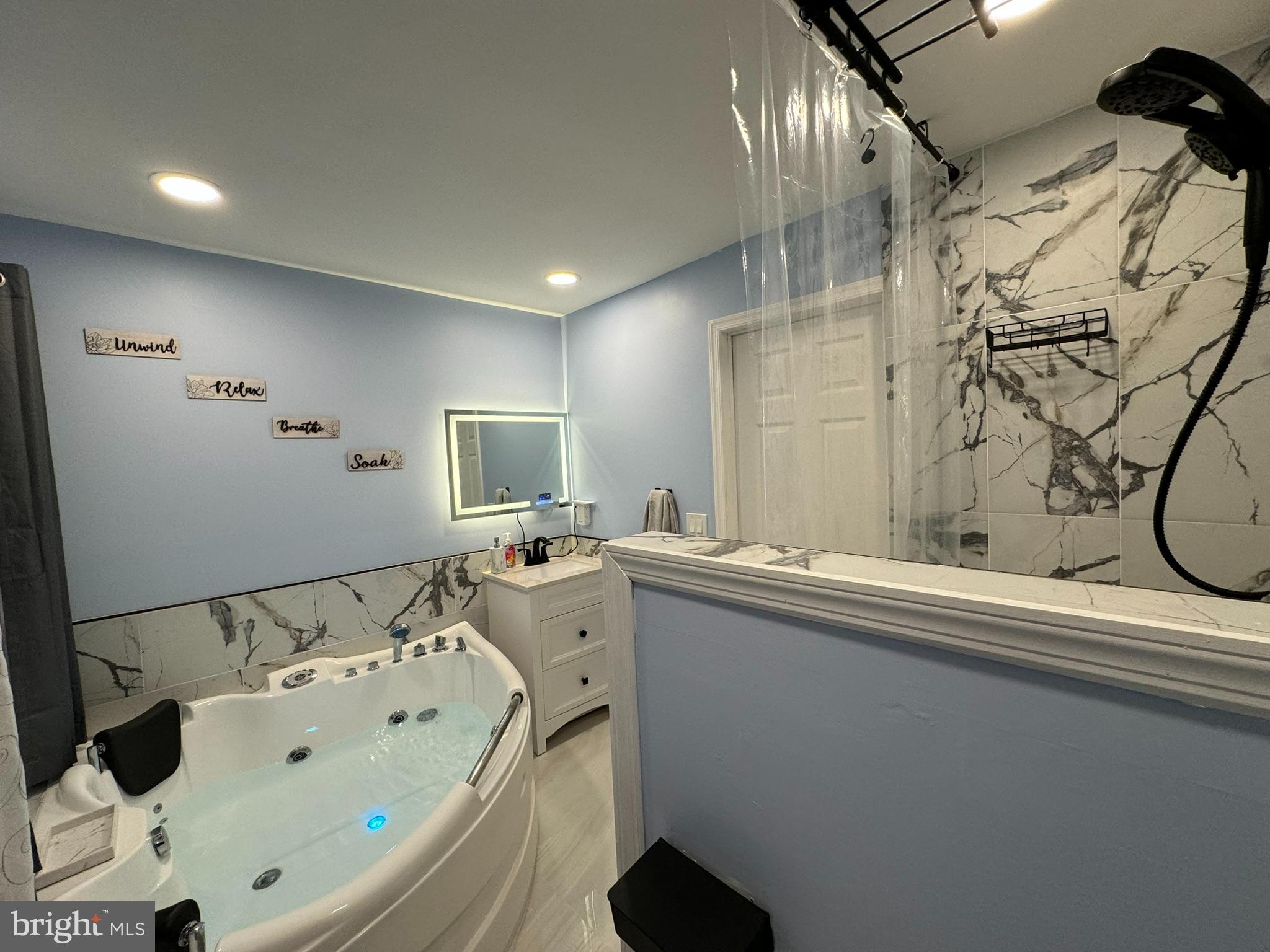 49 Delaware Drive Penns Grove, NJ 08069 - Photo 15 of 26 a bathroom with a bathtub sink and mirror
