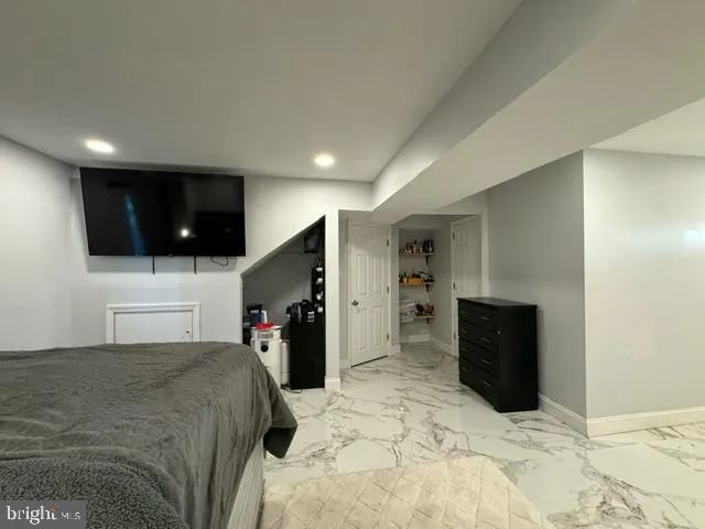 a large bedroom with a bed and a television