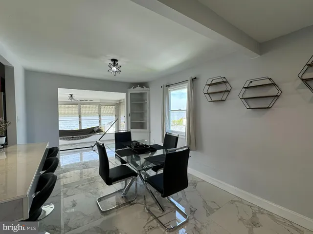 a living room with furniture a flat screen tv and a window