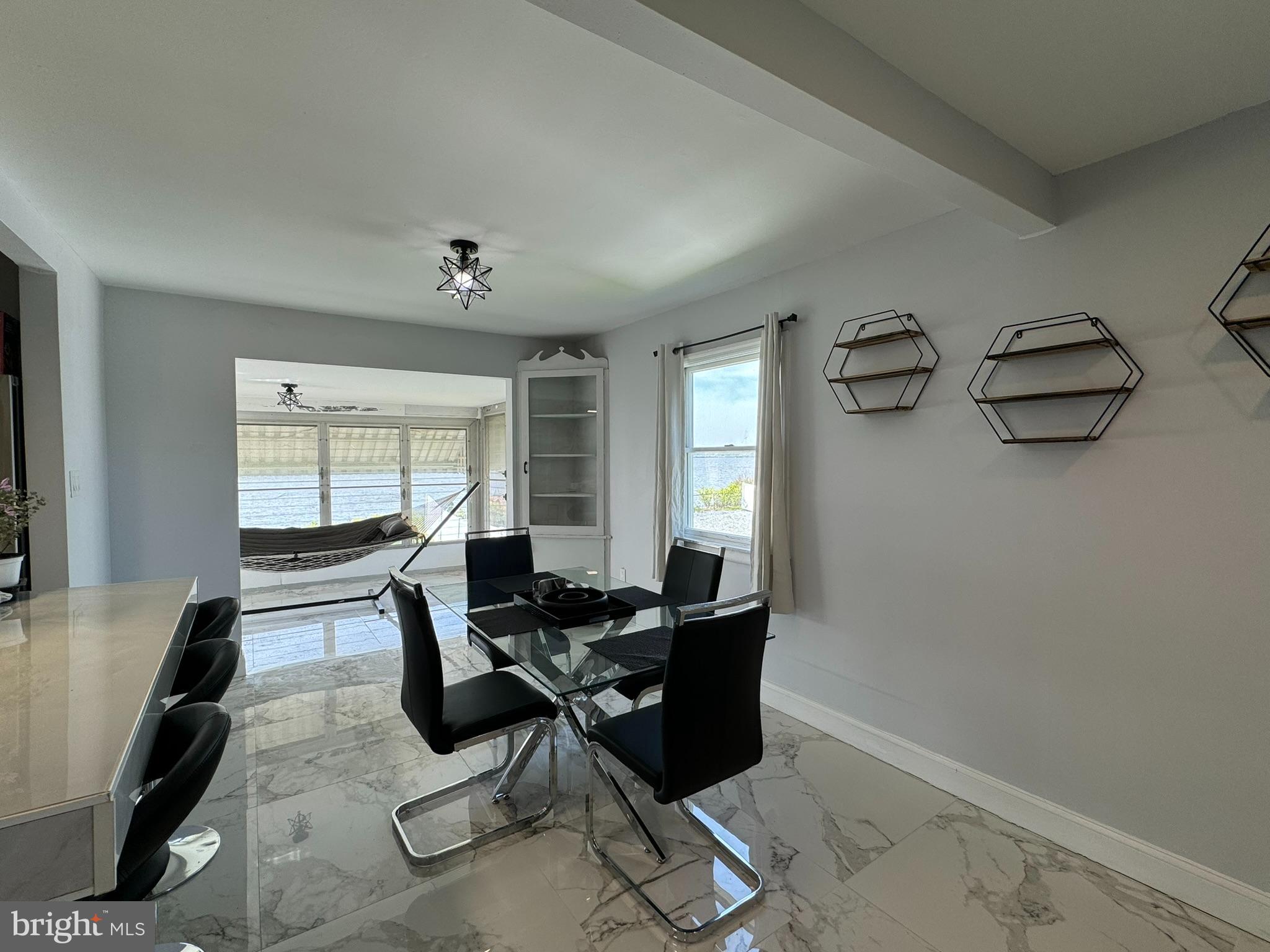 49 Delaware Drive Penns Grove, NJ 08069 - Photo 7 of 26 a living room with furniture a flat screen tv and a window