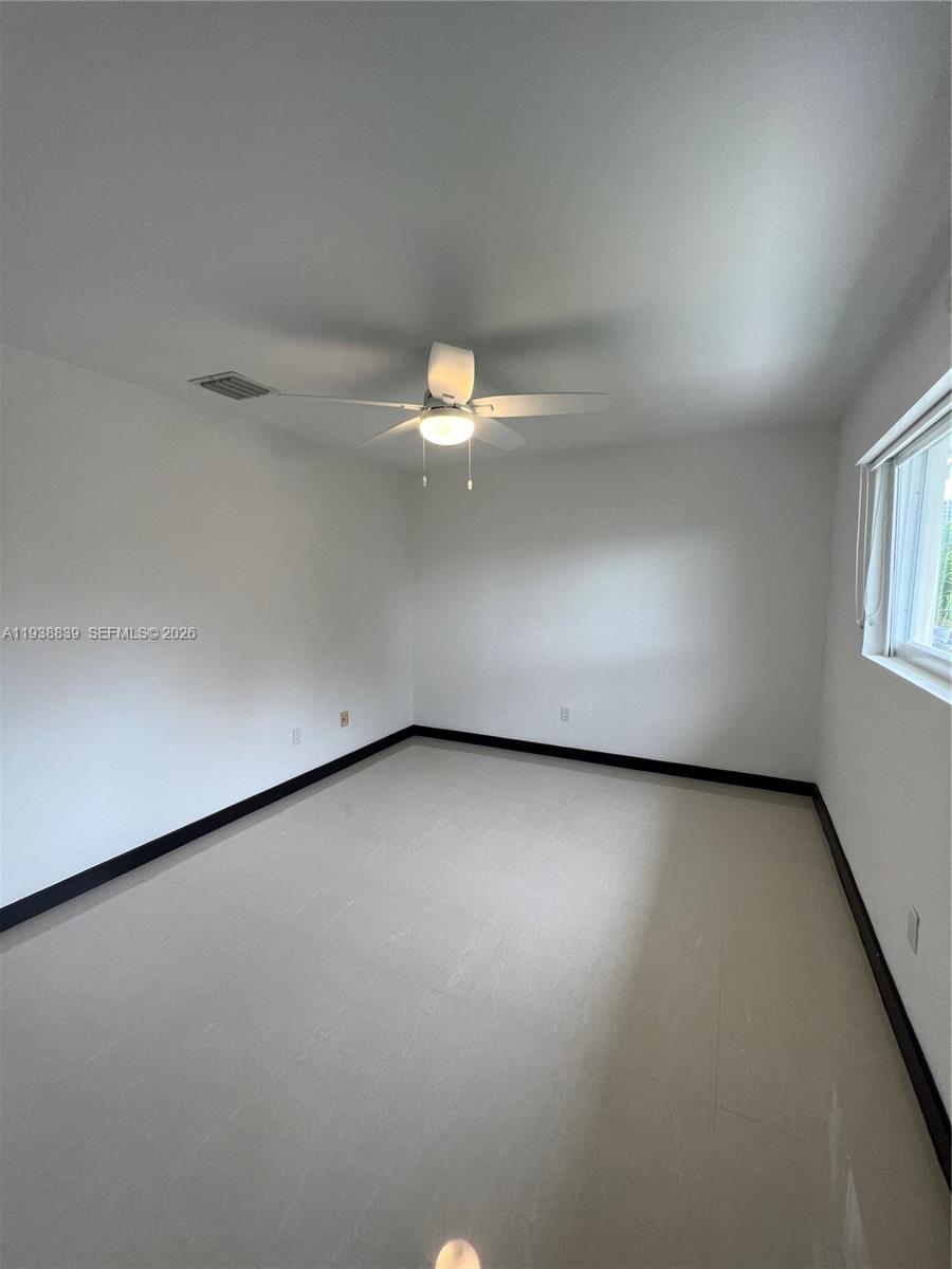 9210 Southwest 73rd Avrd, Unit 9210 Pinecrest, FL 33156 - Photo 12 of 18 an empty room with a window