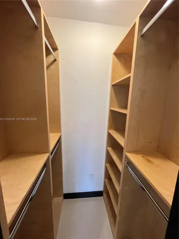 a view of an empty room and wooden floor