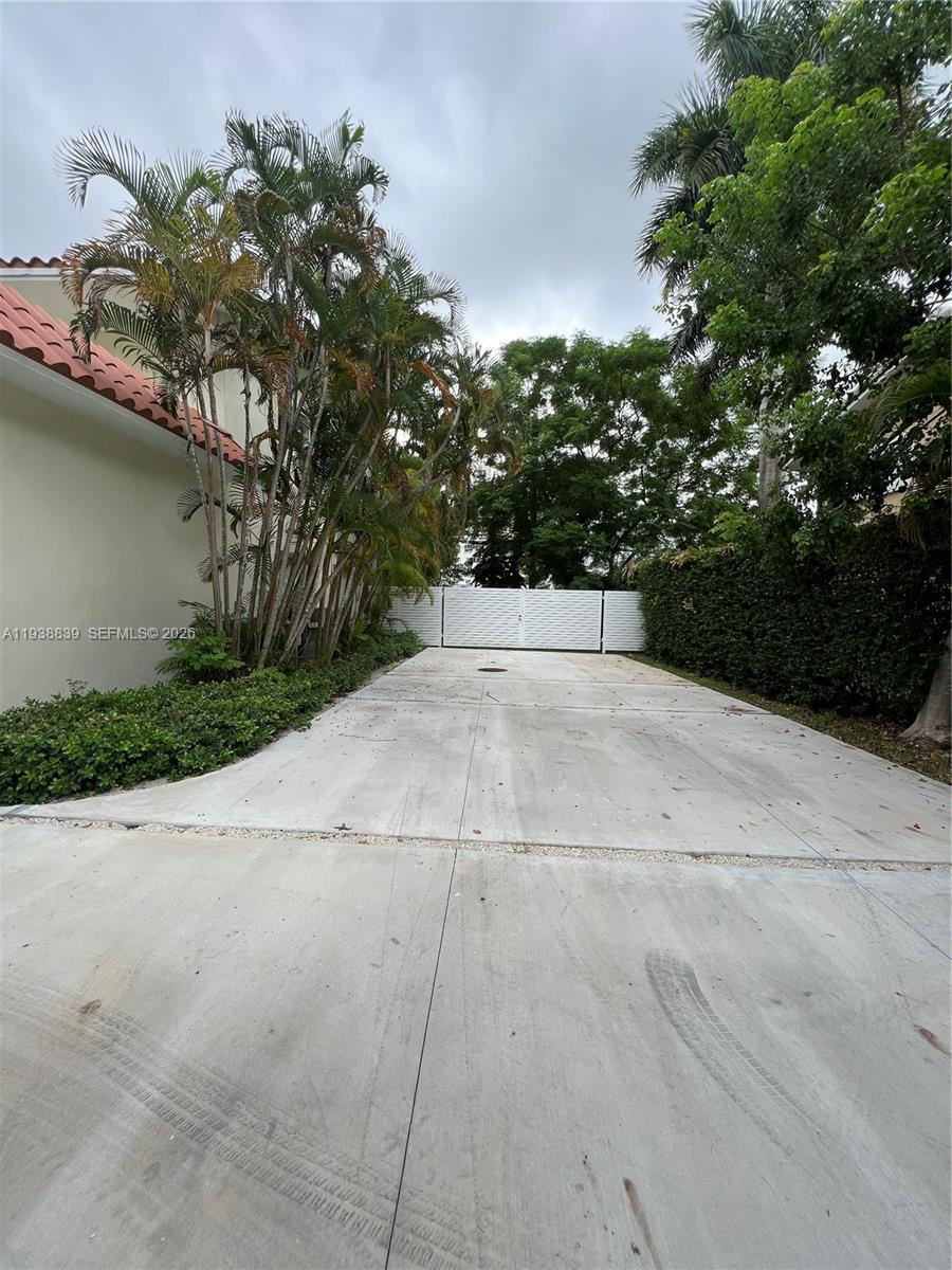 9210 Southwest 73rd Avrd, Unit 9210 Pinecrest, FL 33156 - Photo 17 of 18 a view of a parking space with trees in the background