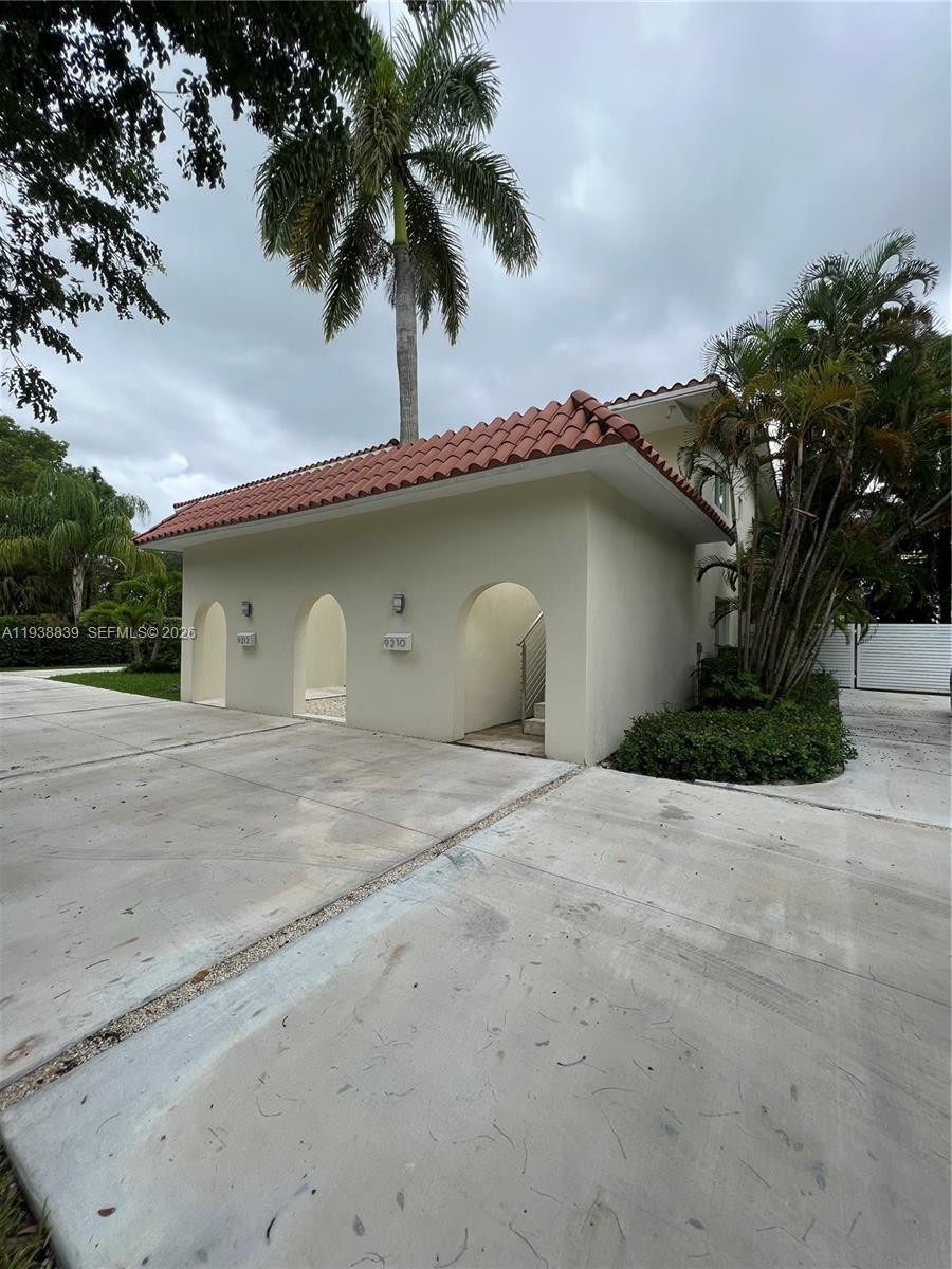9210 Southwest 73rd Avrd, Unit 9210 Pinecrest, FL 33156 - Photo 2 of 18 a house with a garden space