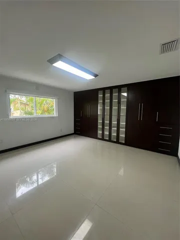 a view of an empty room with windows