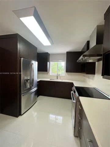 a kitchen with a refrigerator and a sink