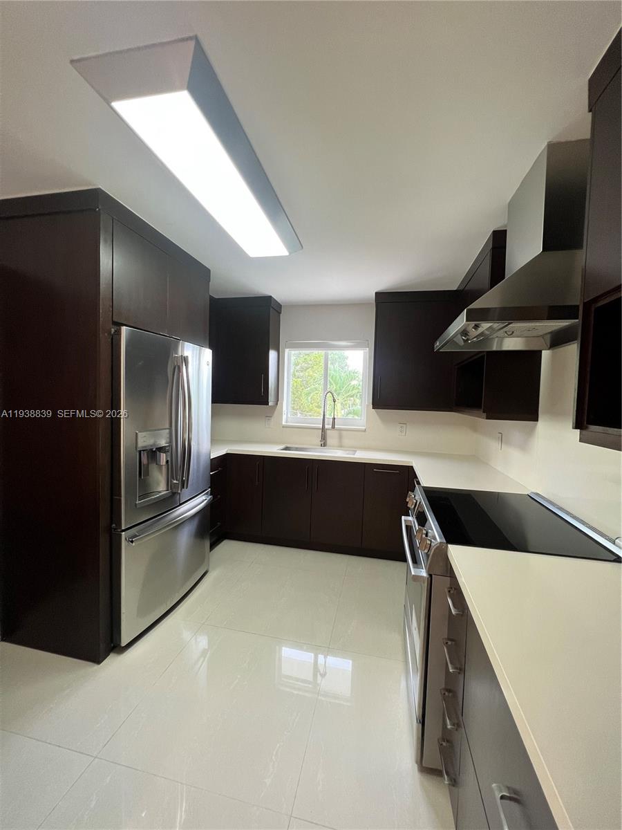9210 Southwest 73rd Avrd, Unit 9210 Pinecrest, FL 33156 - Photo 10 of 18 a kitchen with a refrigerator and a sink