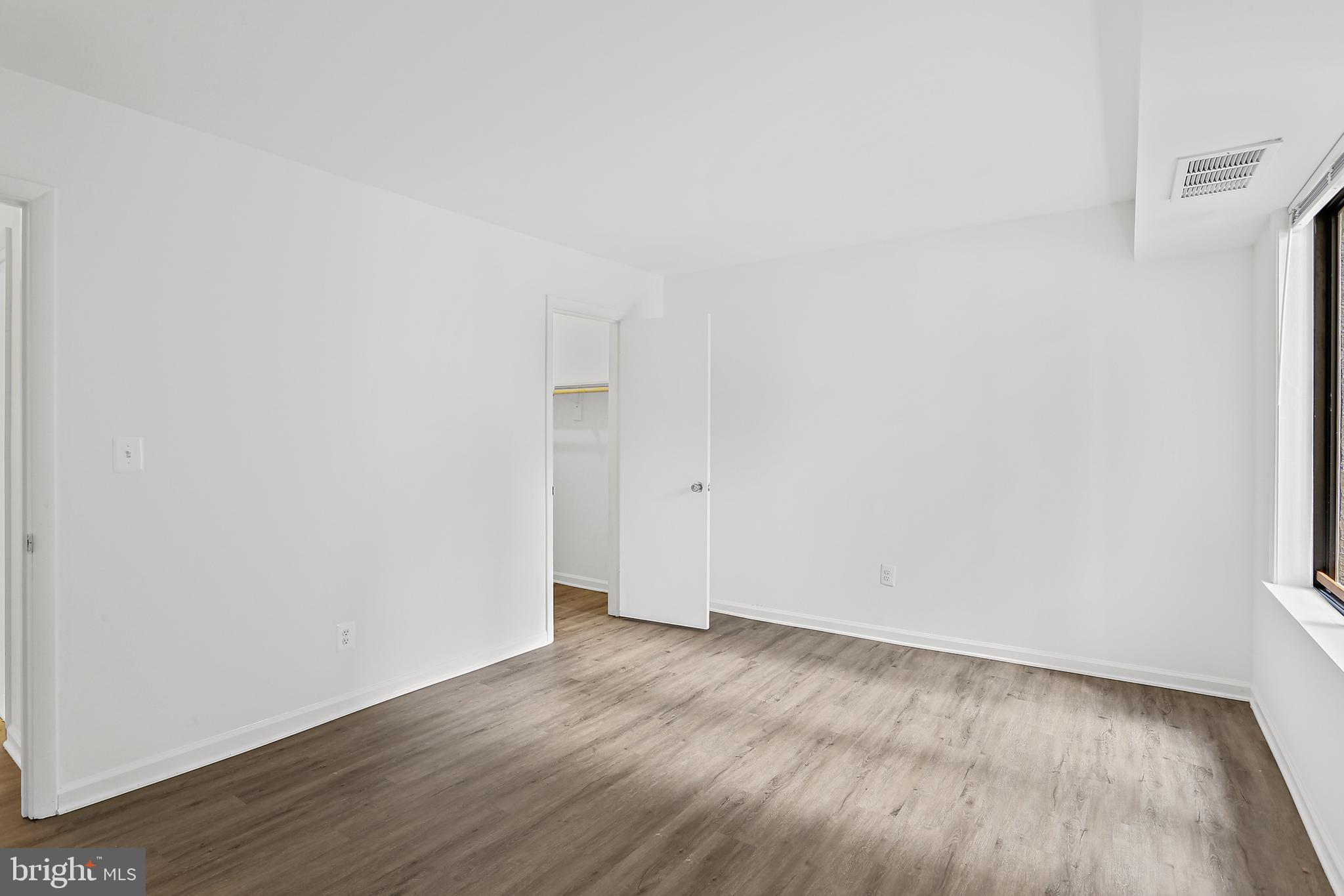 9629 White Acre Road, Unit B2 Columbia, MD 21045 - Photo 10 of 11 a view of an empty room and wooden floor