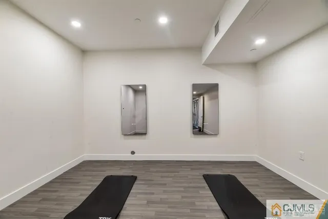 a large kitchen with stainless steel appliances a large counter top