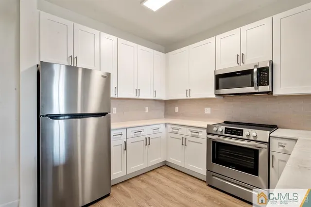a kitchen with a sink stove and microwave