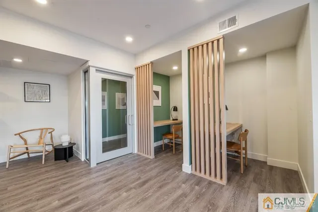 a living room with furniture a flat screen tv and a large window
