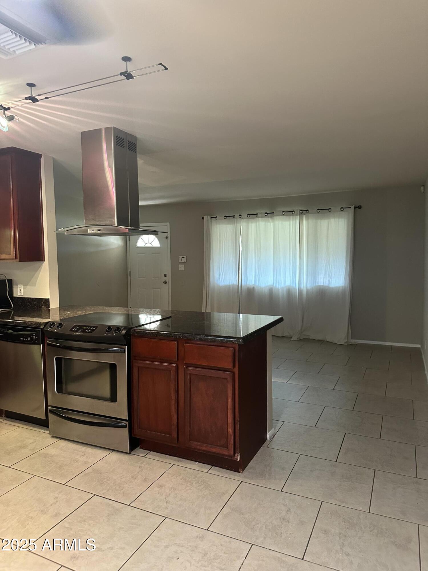 2525 South College Avenue, Unit 2 Tempe, AZ 85282 - Photo 11 of 13 a kitchen with stainless steel appliances granite countertop a stove a sink and a microwave
