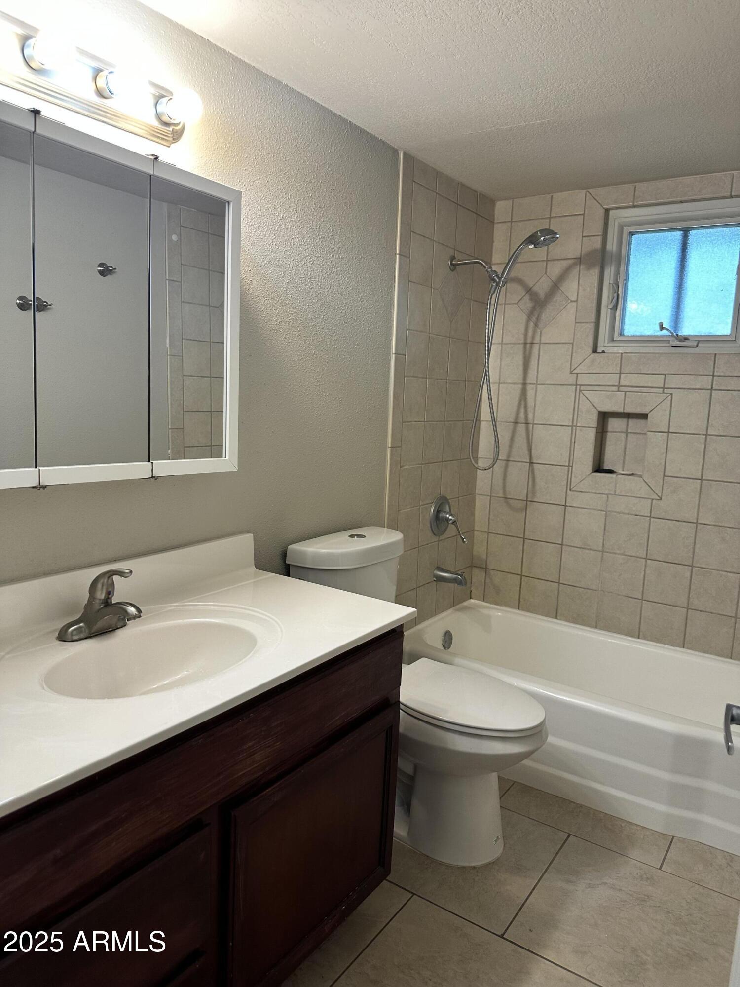 2525 South College Avenue, Unit 2 Tempe, AZ 85282 - Photo 12 of 13 a bathroom with a sink a toilet and shower