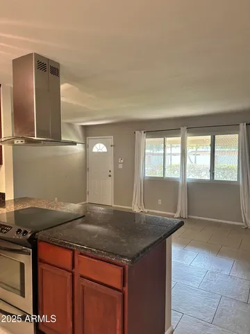 a kitchen with granite countertop a sink and a stove