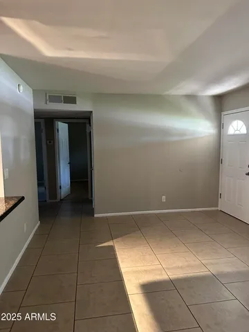 a view of hallway with a bathroom