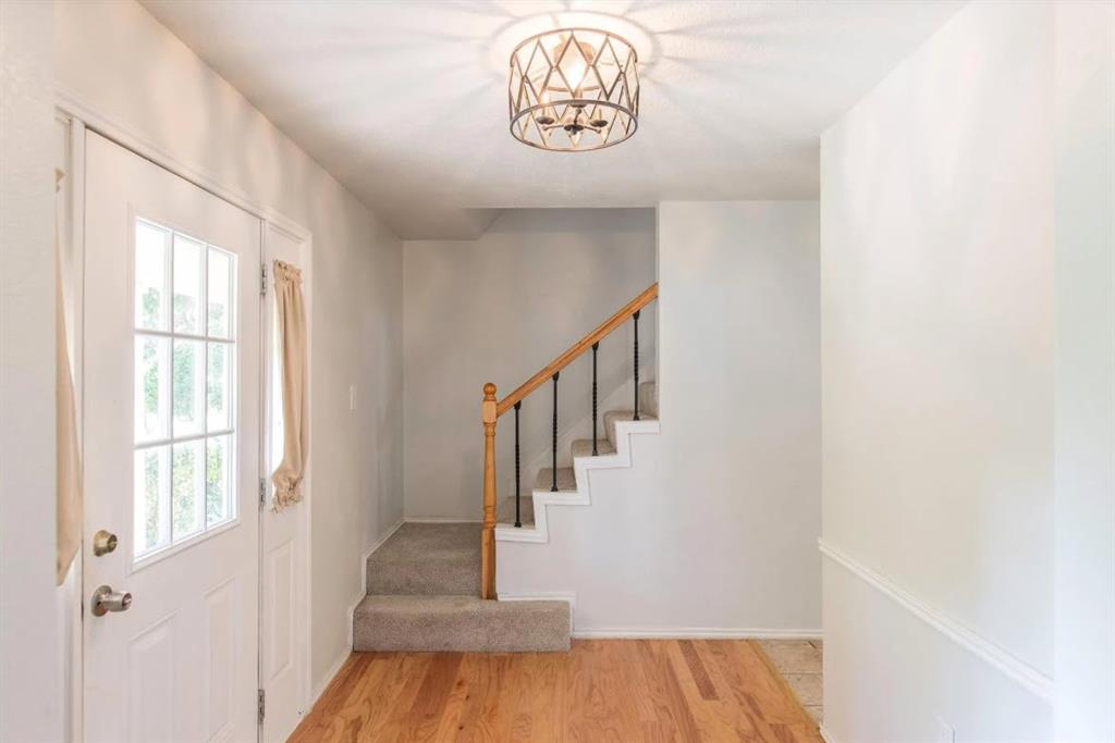 4013 18th Street Plano, TX 75074 - Photo 16 of 39 a view of entryway with stairs and wooden floor