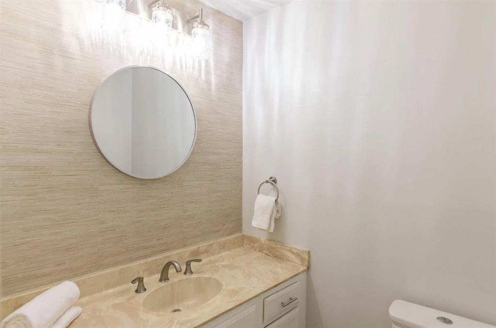 4013 18th Street Plano, TX 75074 - Photo 17 of 39 a bathroom with a sink and a mirror