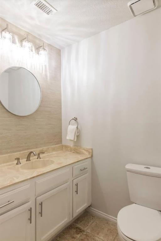 4013 18th Street Plano, TX 75074 - Photo 18 of 39 a bathroom with a toilet sink and mirror