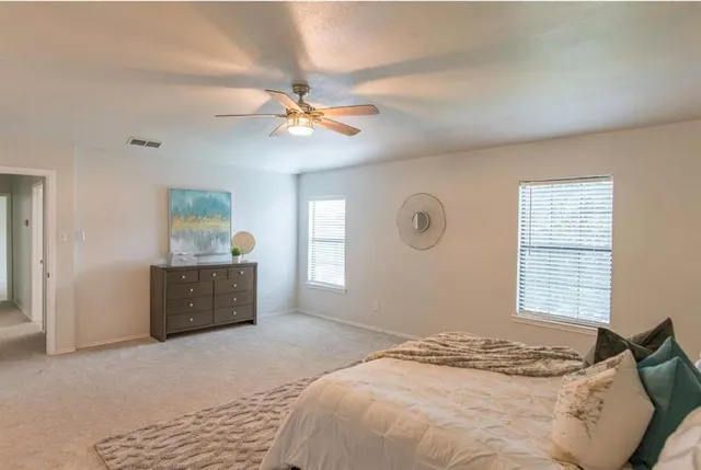 a bedroom with a large bed and a window