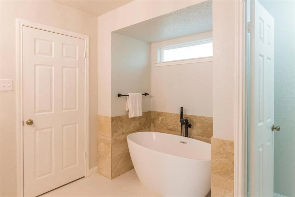 4013 18th Street Plano, TX 75074 - Photo 26 of 39 a bathroom with a white tub