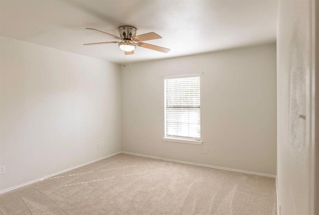 4013 18th Street Plano, TX 75074 - Photo 28 of 39 an empty room with a window and a fan