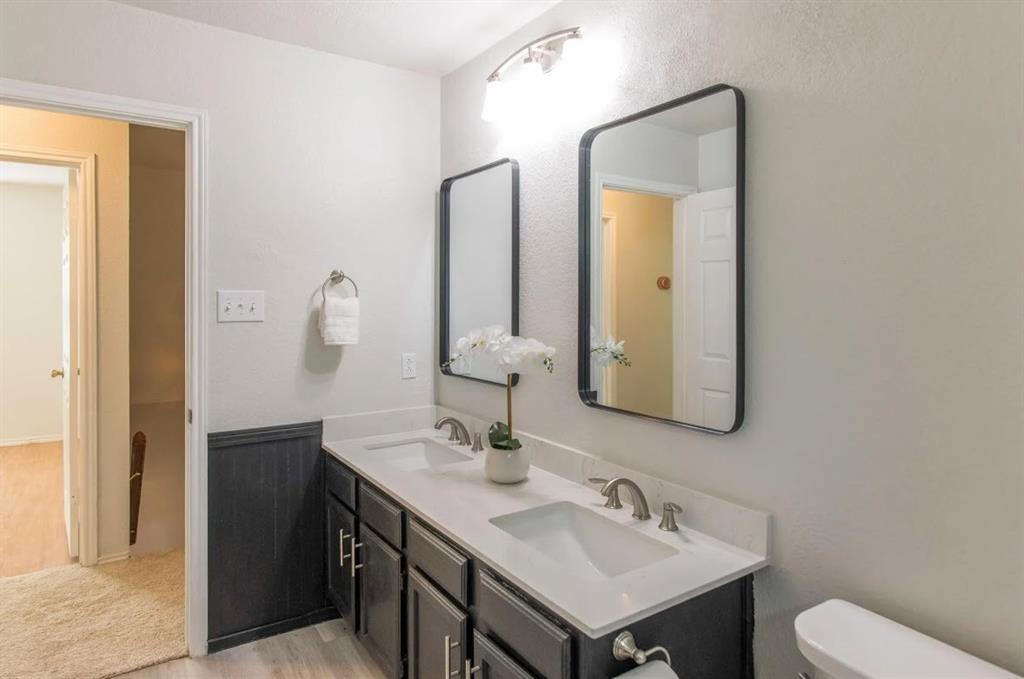 4013 18th Street Plano, TX 75074 - Photo 30 of 39 a bathroom with a toilet sink and mirror