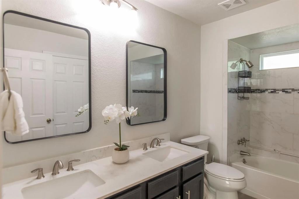 4013 18th Street Plano, TX 75074 - Photo 32 of 39 a bathroom with double vanity sinks and a mirror